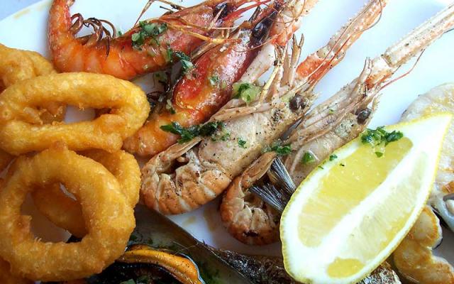 Close-up photo of cooked shrimp on a white plate